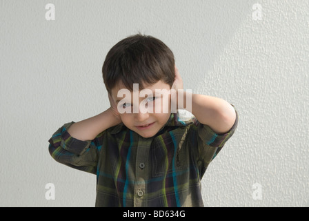 Little boy hands over ears Stock Photo