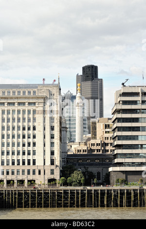 Monument to the Great Fire of London England UK Europe enclosed by modern office buildings with Tower 42 in the background Stock Photo