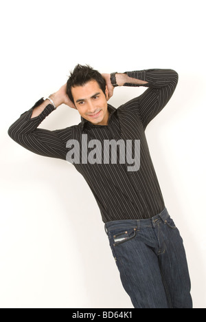Happy man standing with hands behind his head against a white background Stock Photo