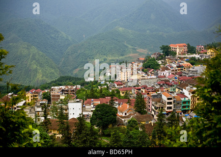 A view of the town of Sapa in northern Vietnam nestled within lush mountainsides Stock Photo