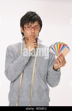 Young man holding colour charts Stock Photo