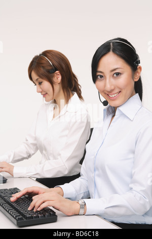 Young japanese women working on laptops Stock Photo