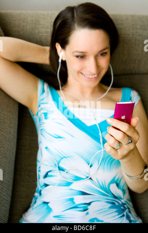 Woman using Ipod Stock Photo