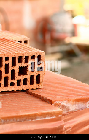 A pile of new bricks at construction site sitting on wooden flat Stock ...