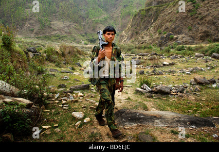 RUKUM DISTRICT NEPAL APRIL 21 2004 Maoist insurgents walk through the mountains to a mobile training camp in Rukum district Stock Photo