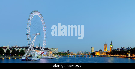 Panoramic shot of the London skyline at dusk, with London Eye at left and Houses of Parliament at right Stock Photo