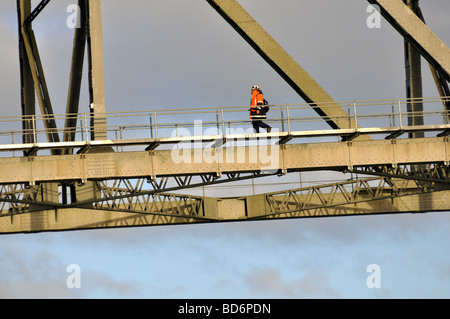 Maintenance worker walking the super structure of Auckland Harbour Bridge Stock Photo