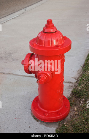 Red fireplug on sidewalk. Stock Photo