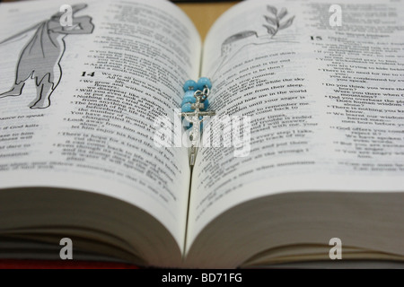 Rosary lying on a bible Stock Photo