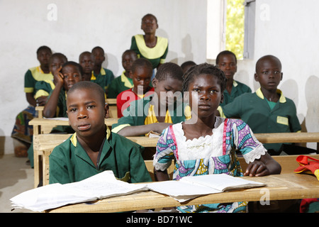 Girl without uniforms with classmates in uniform, during lessons, Mora, Cameroon, Africa Stock Photo