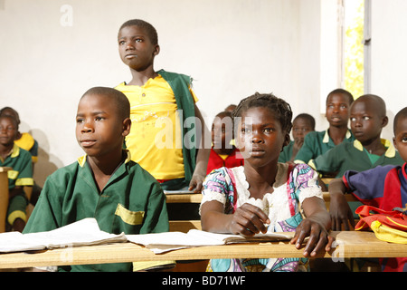 Girl without uniforms with classmates in uniform, during lessons, Mora, Cameroon, Africa Stock Photo