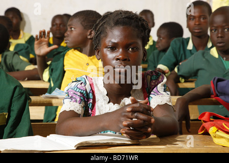 Girl without uniforms with classmates in uniform, during lessons, Mora, Cameroon, Africa Stock Photo