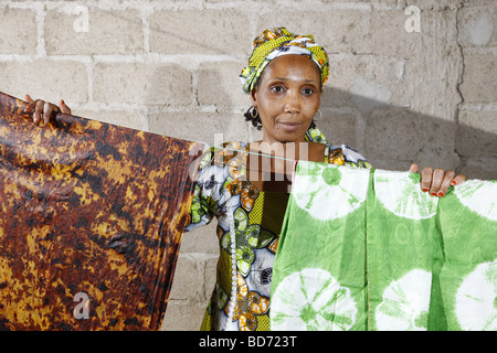 Woman hanging batik dyed fabric on a line, working from home, Maroua, Cameroon, Africa Stock Photo