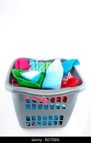 laundry basket filled with colorful towels isolated over white Stock Photo