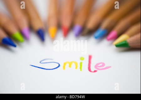Coloured smile on paper and colouring pencils Stock Photo