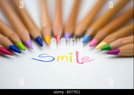 Coloured smile on paper and colouring pencils Stock Photo