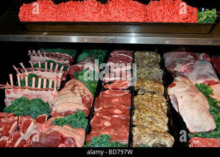 Meat cooler display case with lamb frenched racks steaks leg roasts marinated ground beef Stock Photo