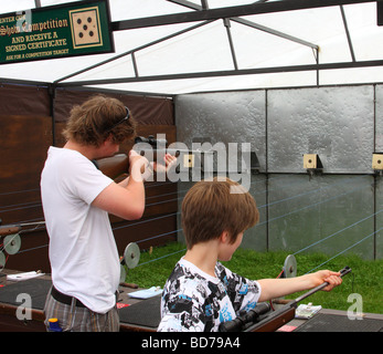 Teenagers on a shooting range at an English country show. Stock Photo