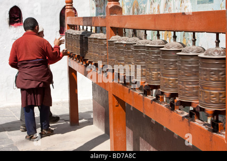 Bodhnath, Nepal.  Buddhist Worshiper Turning Prayer Wheels. Stock Photo