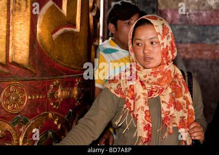 Bodhnath, Nepal.  Buddhist Worshiper Turning Prayer Wheel, Tsamchen Gompa (Monastery). Stock Photo