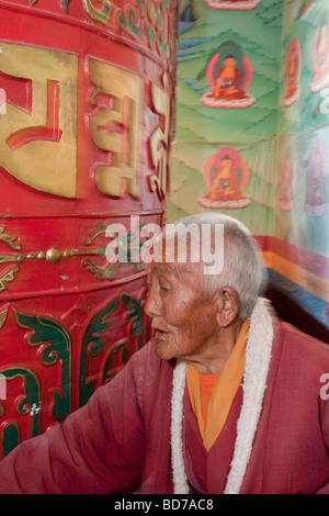 Bodhnath, Nepal. Buddhist Worshiper Turning Prayer Wheel, Tsamchen Gompa. Stock Photo