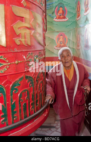 Bodhnath, Nepal.  Buddhist Worshiper Turning Prayer Wheel, Tsamchen Gompa. Stock Photo