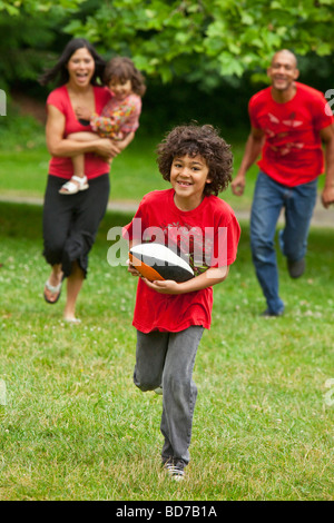 Family running in park Stock Photo