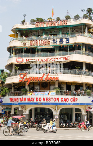 A tall building with restaurants and cafes overlooking traffice in central Hanoi, Vietnam Stock Photo