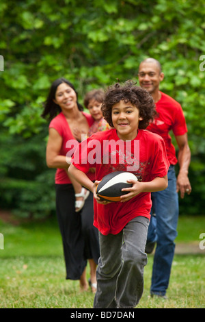 Family running in park Stock Photo