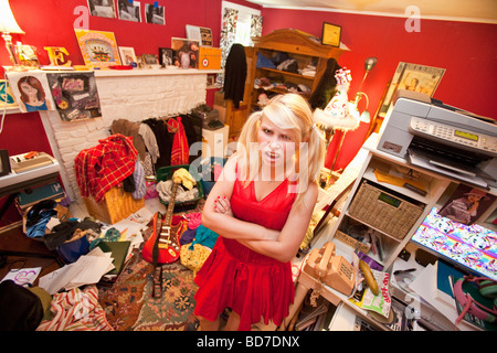 Teen girl in messy room Stock Photo