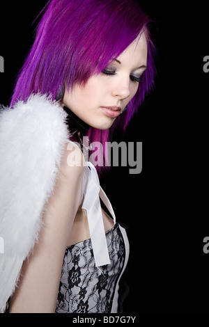 Shot of an Alternative Purple Haired Girl with Angel Wings against a Black Background Stock Photo