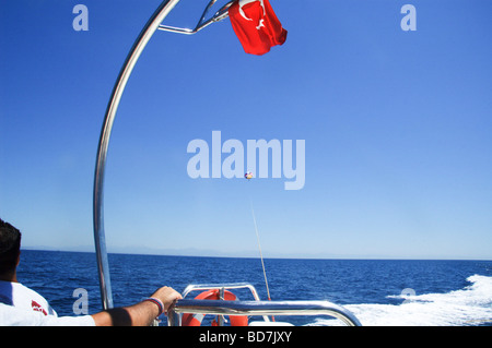 Para sailing towed by boat Stock Photo