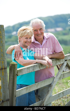 mature couple leaning on gate Stock Photo