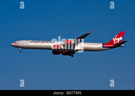 Virgin Atlantic Airbus A340-600 named 'Miss Behavin' with landing gear down. Stock Photo