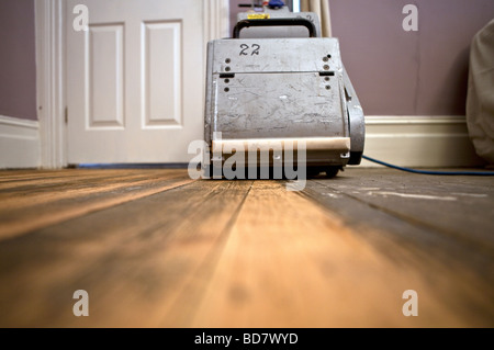 Sanding floorboards. Stock Photo