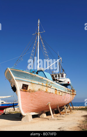 Fishing boat or trawler undergoing maintenance in a dry dock in Latchi, Paphos, Greece Stock Photo