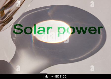 Solar power concentrating the suns power through a magnfying glass Stock Photo