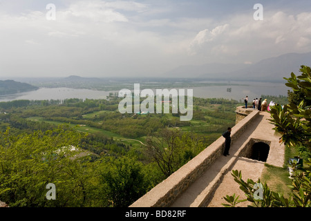 Indian tourists take in the view over Dal Lake from an old fort on a hilltop Stock Photo