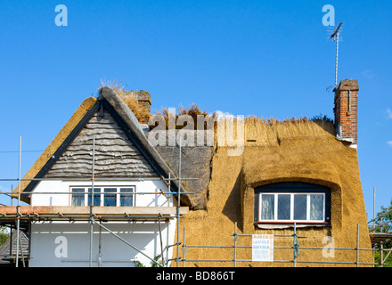 A thatched cottage in the process of being re-roofed at Walberswick, Suffolk, England Stock Photo