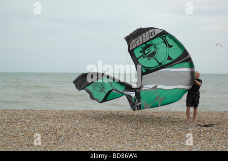 Kitesurfer Preparing Their Kite On The Beach With Storm Clouds In The 