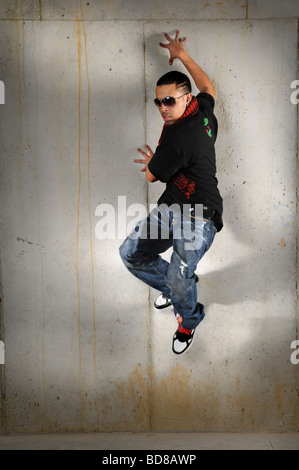 African American hip hop man jumping against the wall Stock Photo