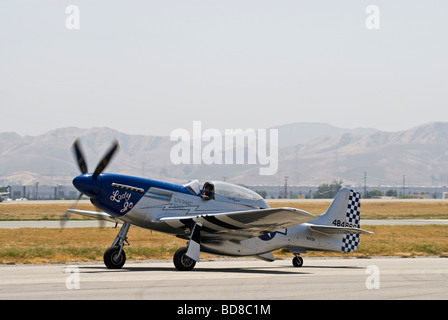 A P-51 Mustang taxis on the runway after flying at an air show. Stock Photo