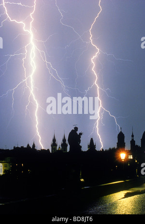 Lightning storm over Charles Bridge and Baroque statues in Prague at night. A real image.  NOT photo shopped. Stock Photo