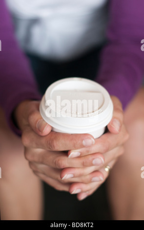 Person holding coffee in a take away paper cup close up Stock Photo