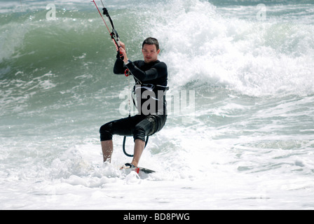 A man kitesurfing close up in rough seas Stock Photo