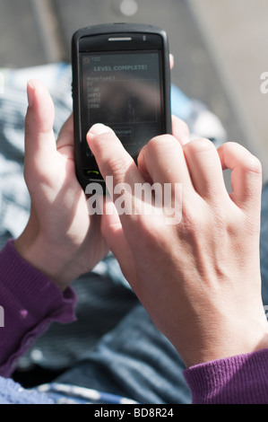 Close up of woman playing games on touch screen smart phone Stock Photo