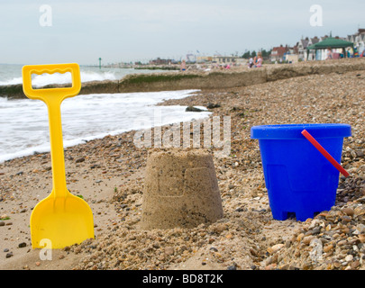 Shallow focus on a Bucket and spade and a sand castle on Felixstowe beach in Suffolk England. Stock Photo