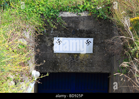 German Swastika on the entrance to the Second World War bunker on the Jerbourg Point, Guernsey, Channel Islands Stock Photo