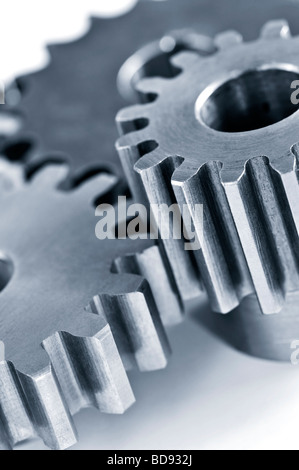 Interlocking industrial metal gears isolated on white Stock Photo - Alamy