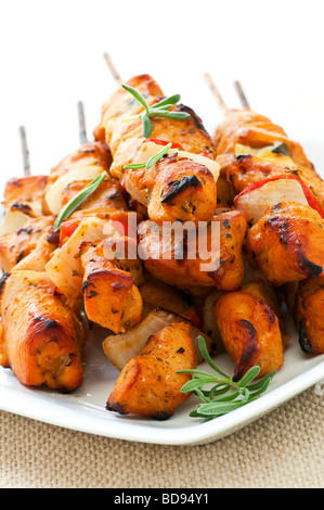 Pile of barbecued chicken kebab appetizers on a plate Stock Photo